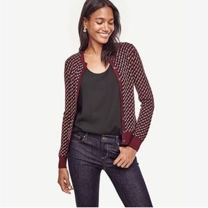 Ann Taylor button front cardigan in herringbone pattern with burgundy trim.